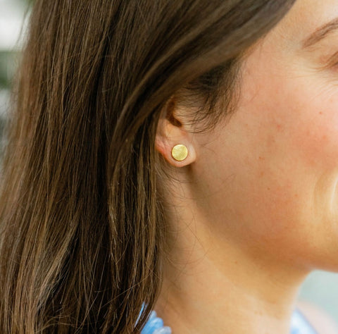 Woman wearing a gold circular earring