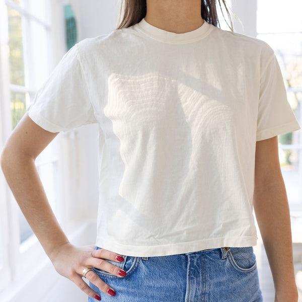 Model wearing a white t-shirt and blue jeans