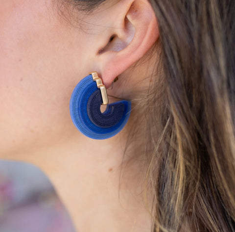 Model wearing chunking blue ombre three layered hoop earring