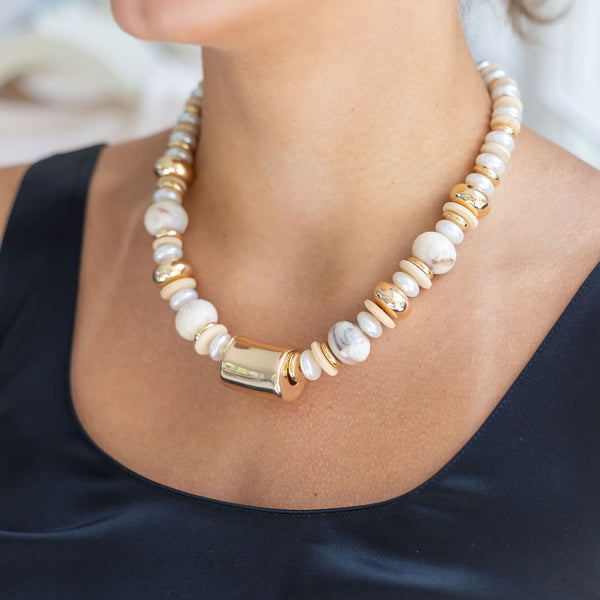 Woman wearing a resin white/gold link necklace