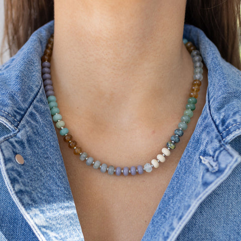 Model wearing blue, amber and white beaded necklace