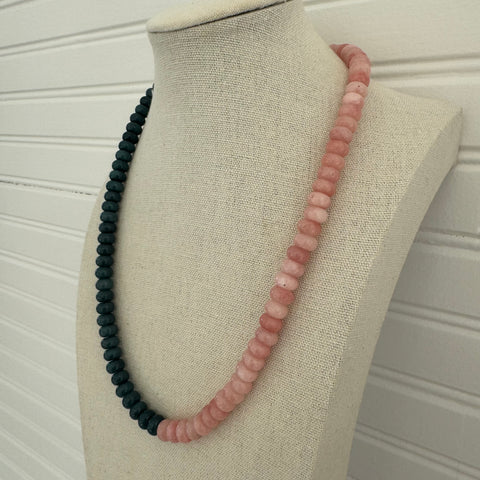 Necklace of dark blue and pink beads.