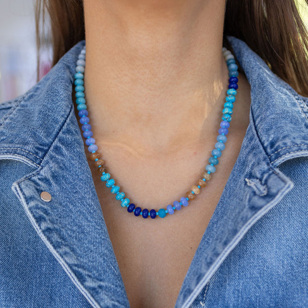 Model wearing blue and tan beaded necklace