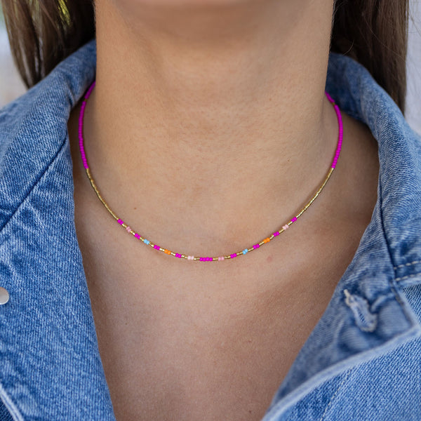 Dainty pink, gold, orange and turquoise beaded necklace on model