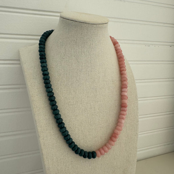 Necklace of dark blue beads and pink beads.