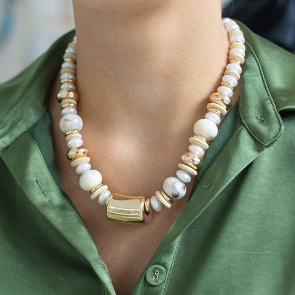 Woman wearing a resin white/gold link necklace