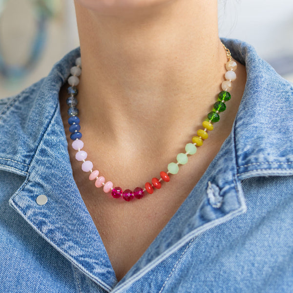 Woman wearing a rainbow colored beaded short necklace