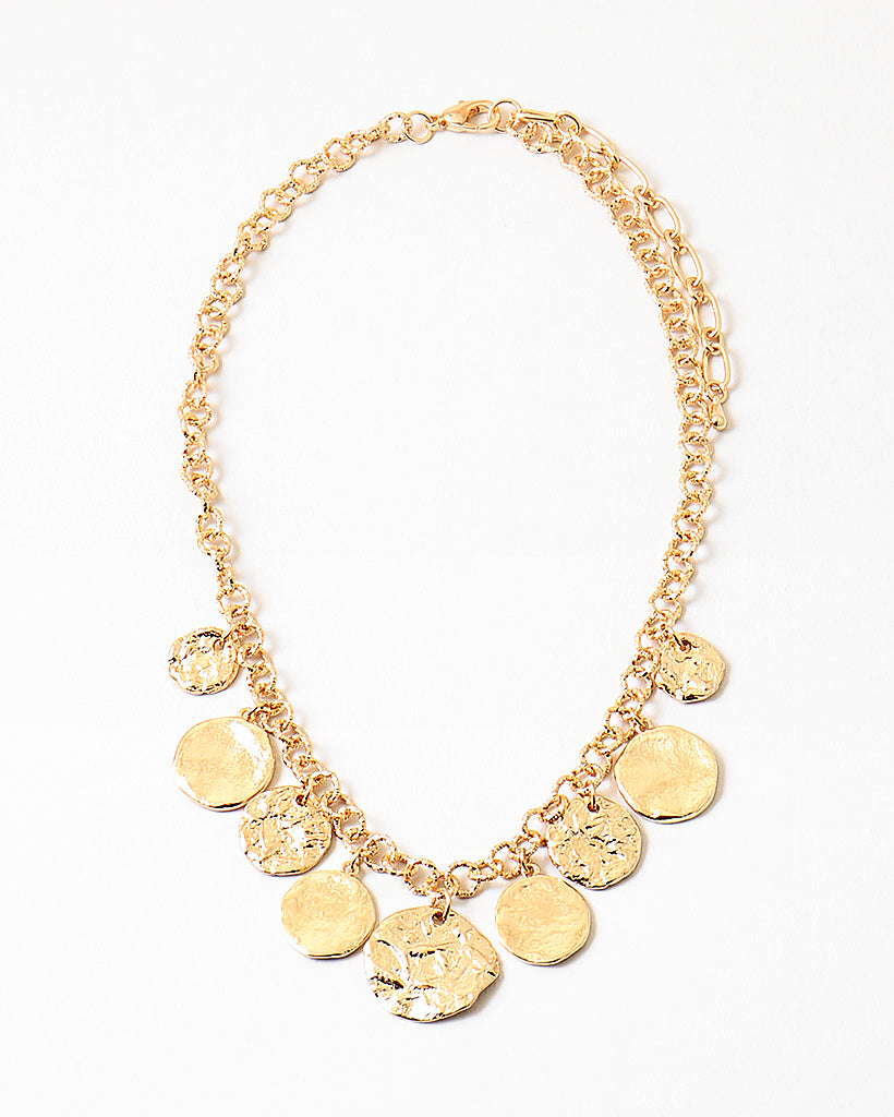 Picture of gold chain with nine hammered gold disc pendants.