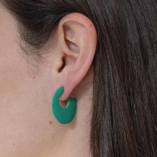 Picture of model wearing a chunky mint green hoop earrings.