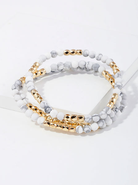 Picture of a set of three bracelets with white marble beads and gold beads