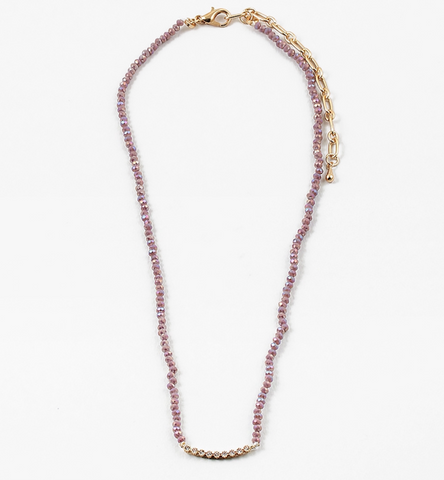 A necklace with light purple faceted stones with quartz and gold  