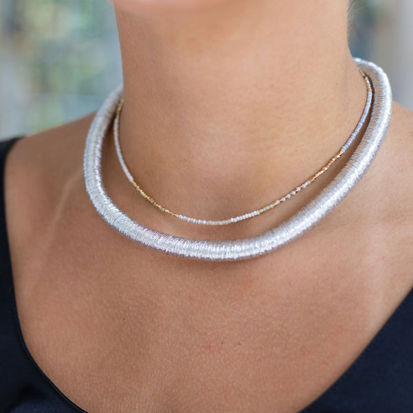 Woman wearing a silver choker around her neck