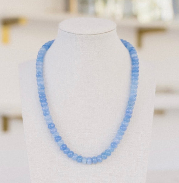 Picture of a bright light blue beaded necklace.