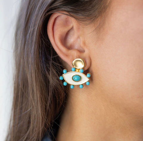 Model wearing gold and turquoise evil eye earring