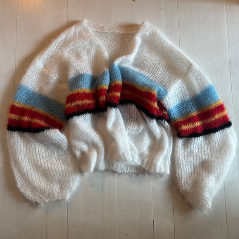 Picture of white sweater with retro light blue, yellow, maroon and black striping.