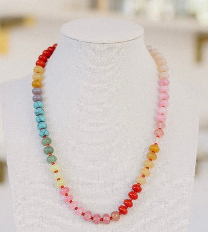 Multicolored necklace in red, orange, purple, blue, creams and pinks.