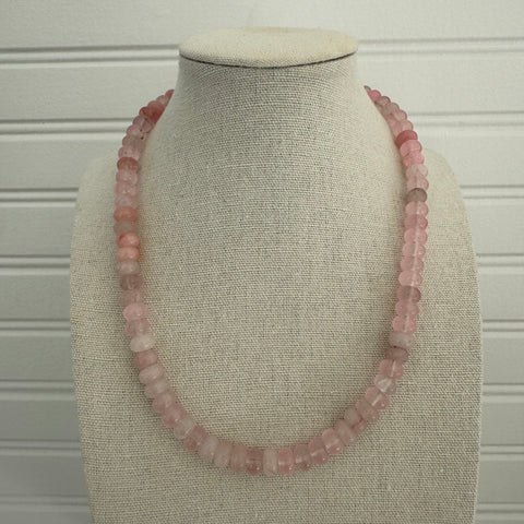 Necklace made out of pink beads.