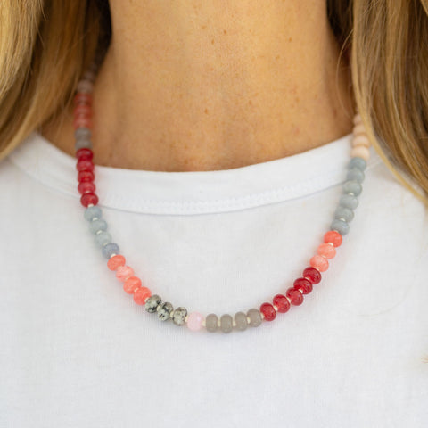 Red, gray, coral and green tinted beaded necklace.