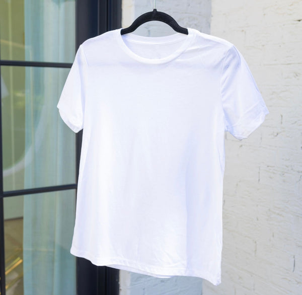 A plain short-sleeve white t-shirt hanging on a black coat hanger 