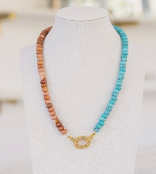 Clay and turquoise colored beaded necklace with a gold clasp.