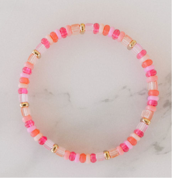 Picture of a single beaded bracelet in alternating colors of pink, coral, gold and white