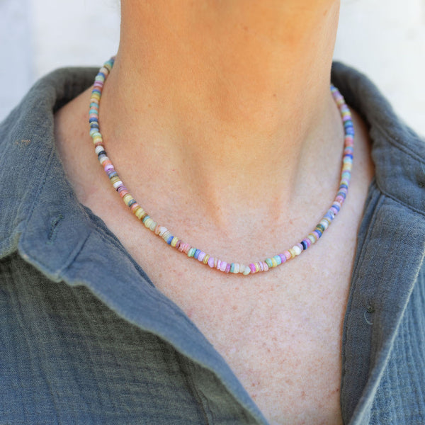 Woman wearing a multi-colored beaded short necklace/choker around her neck