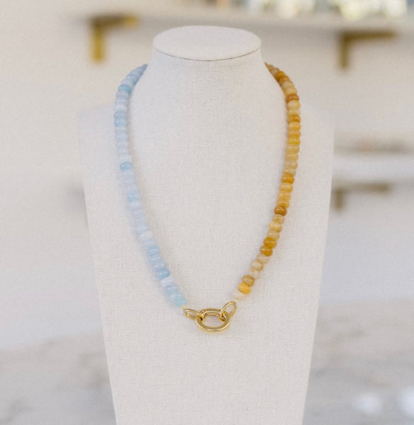 Light blue and amber beaded necklace with a gold clasp.