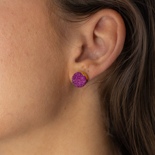 Model wearing purple druzy stud earring in gold setting