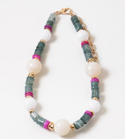 A short necklace with colorful resin beads with a mix of cream, gray, pink, and gold