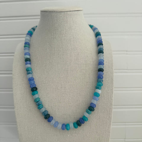 Necklace of dark and light blue beads.