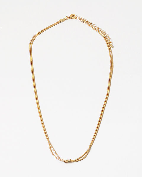 Dainty gold necklace with a petite knot in the center