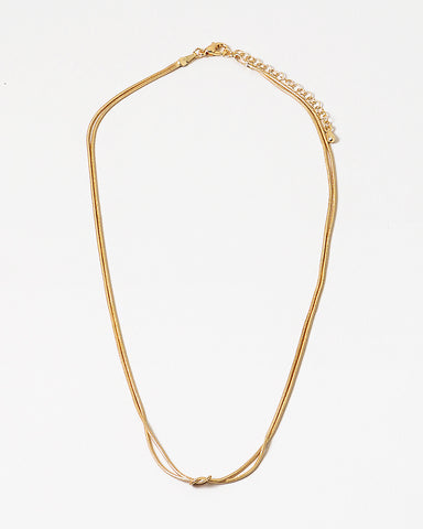 Dainty gold necklace with a petite knot in the center