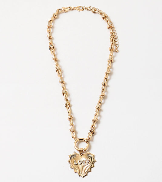 Gold chain toggle necklace with a gold heart medallion that says Love on it