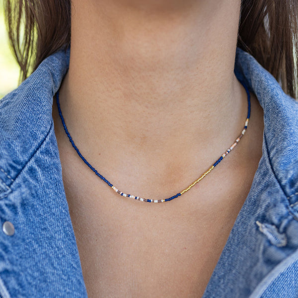 Dainty blue, white and gold beaded necklace on model