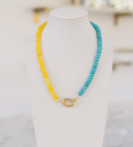 Yellow and turquoise colored beaded necklace with a gold clasp.