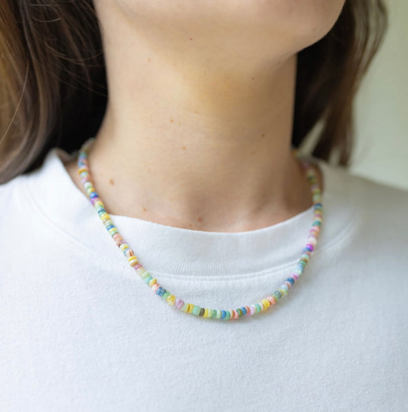 Woman wearing a multicolored beaded short necklace 