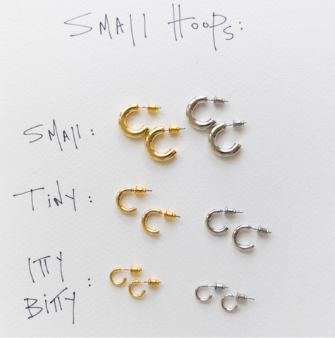 Three sets of silver and gold hoop earrings in a row varying from small to big sizes