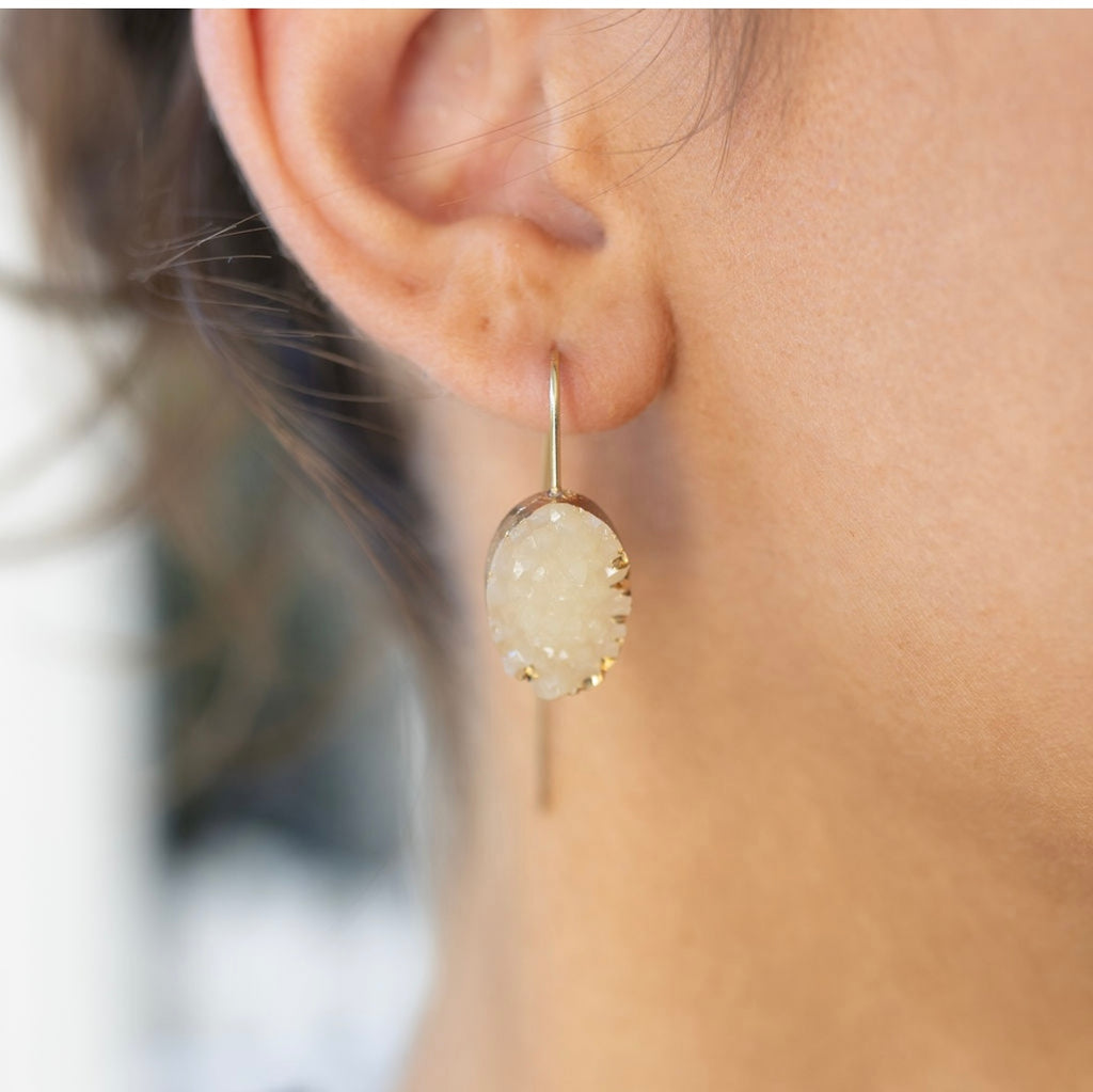 Model wearing a dangling quartz in silver setting earring